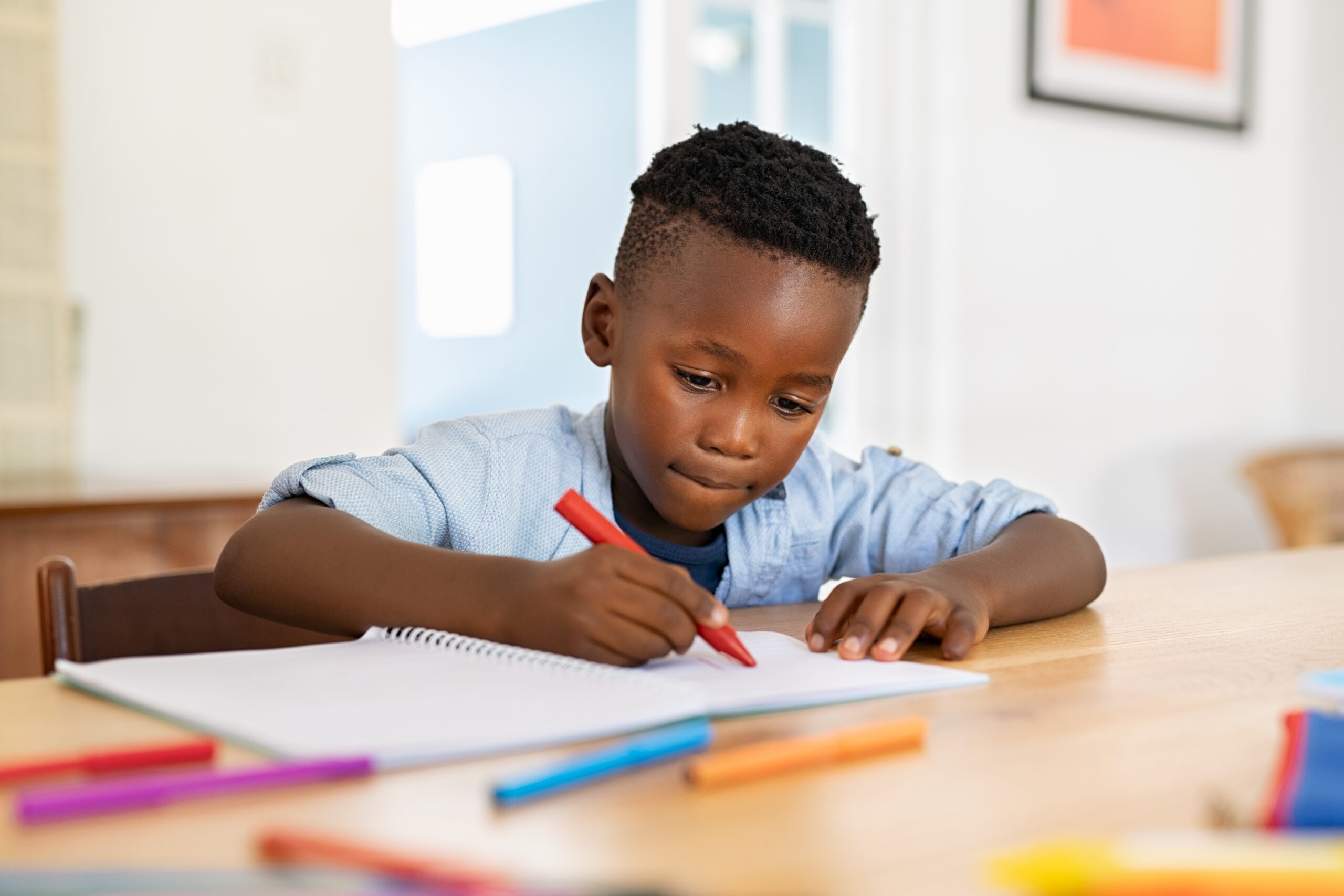 Boy coloring with crayons