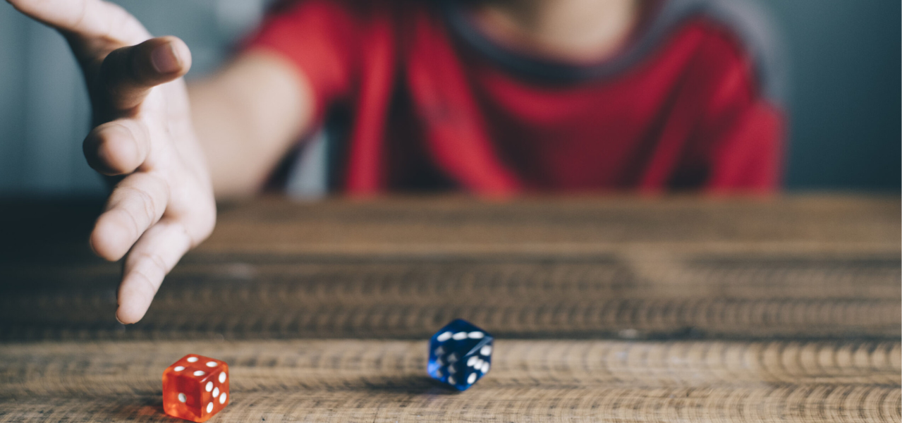 A young child rolling a pair of dice in a fun learning game. 