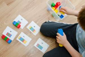 Child using building blocks to play this fun counting game!