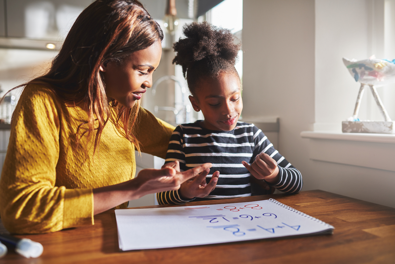 mom and child doing homework at kitchen