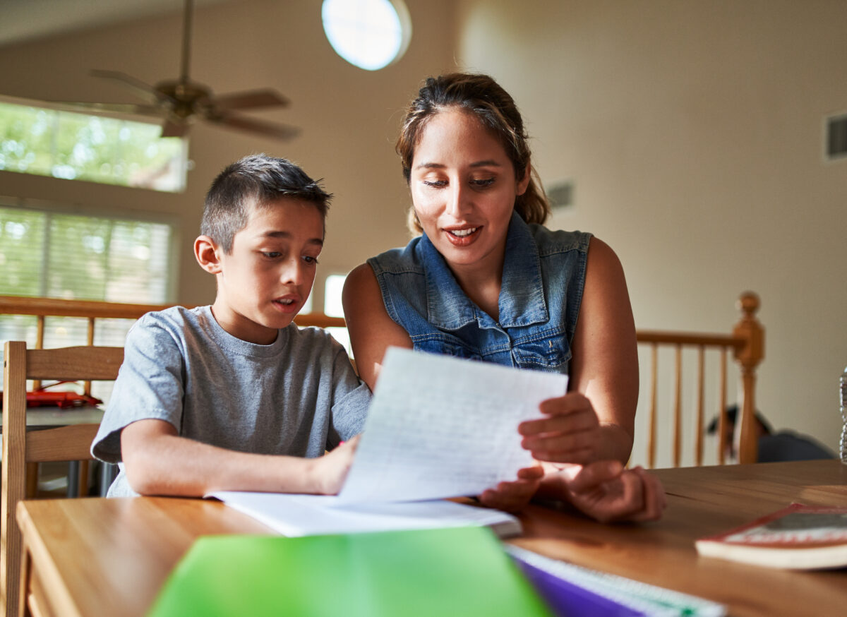 Mother and son reading a worksheet together. 