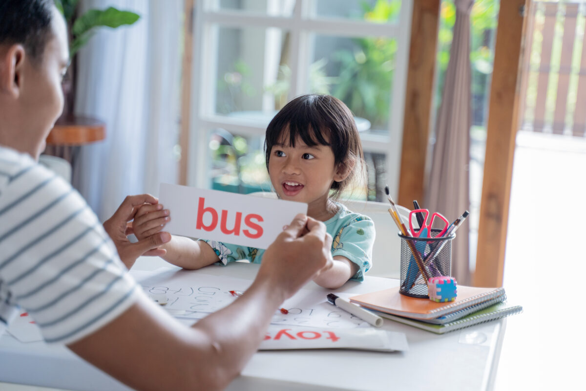 Mother teaching her 1st grader how to blend letter sounds. 