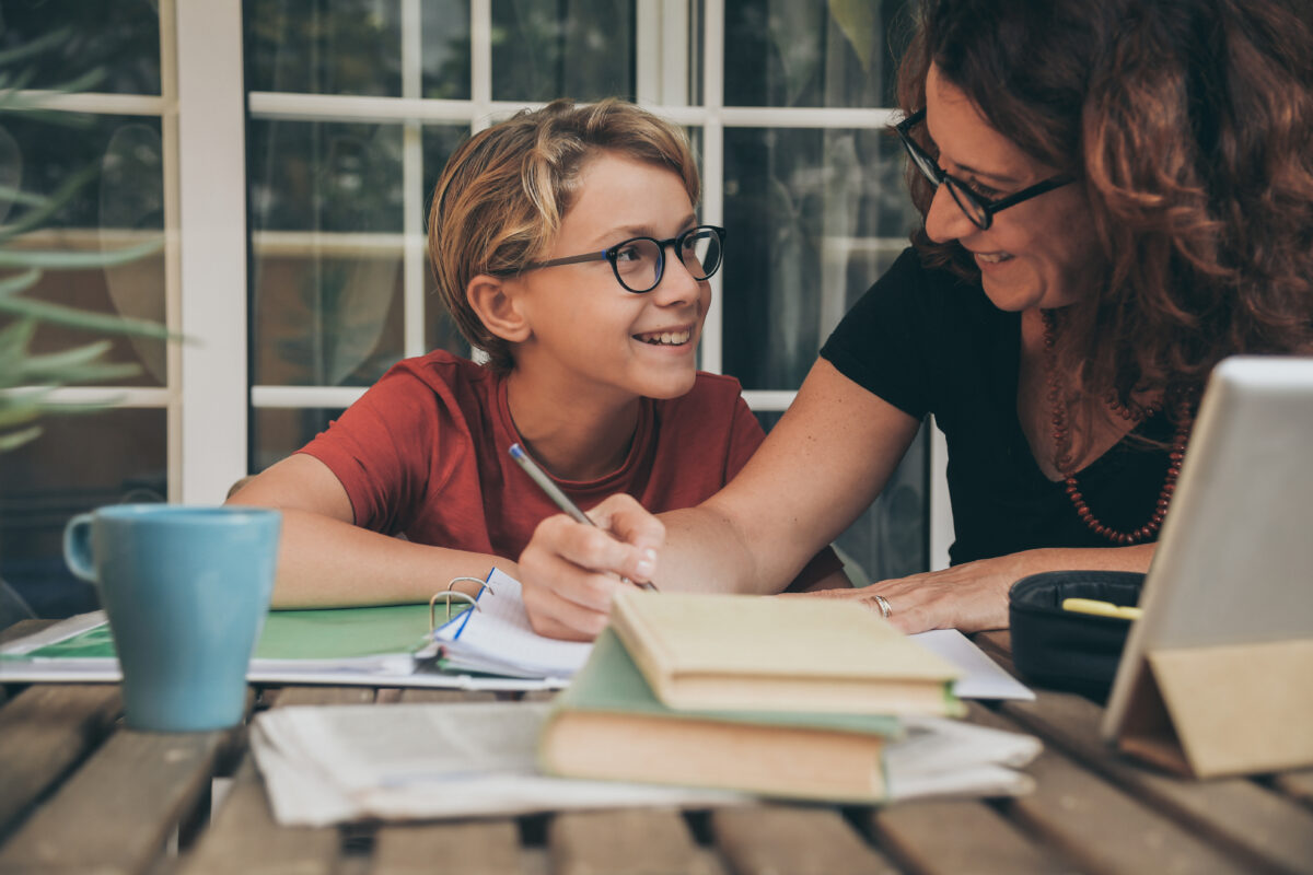 Mother and son doing school work together. 