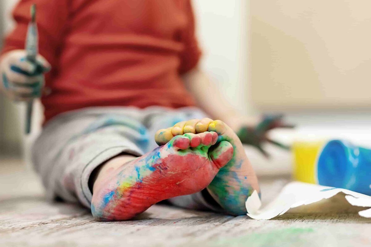 Child with paint on the bottom of their feet. 