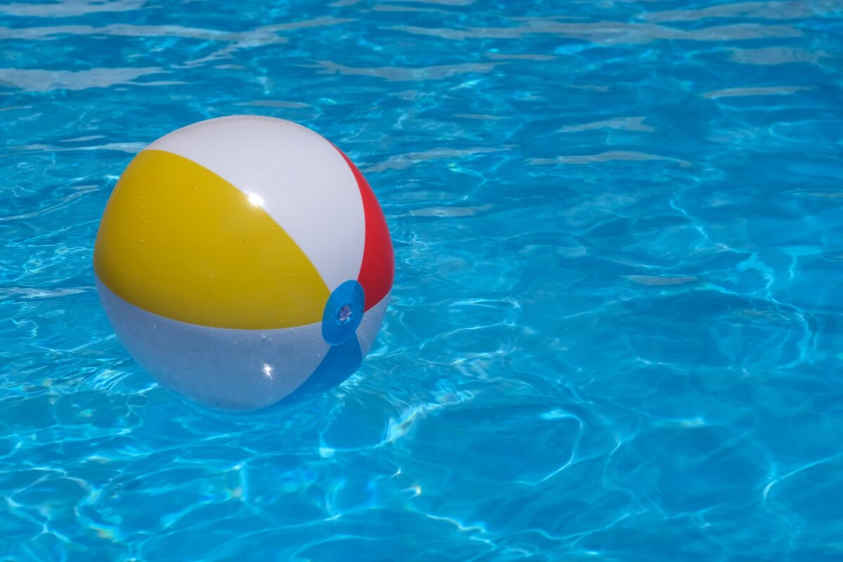 Beach ball floating in a pool. 