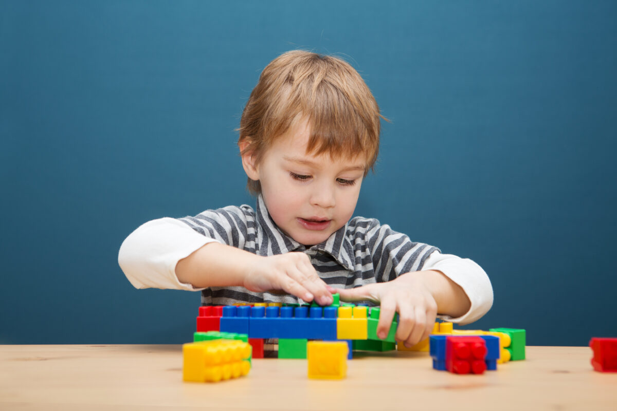 Child playing with lego blocks. 