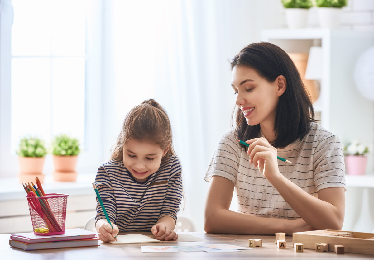 Mother and daughter playing a sight word game together. 