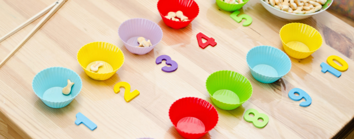 Counting goldfish crackers with silicone cupcake holders and colorful numbers. 