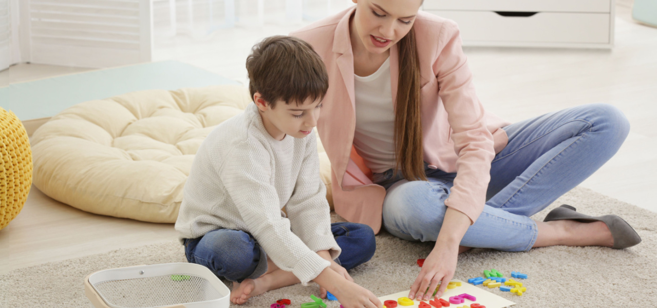 Mother and child working on a school project together. 