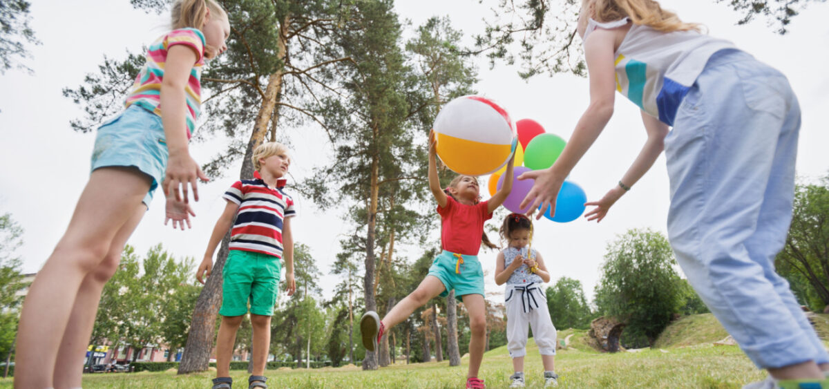 Children playing with beach balls. 