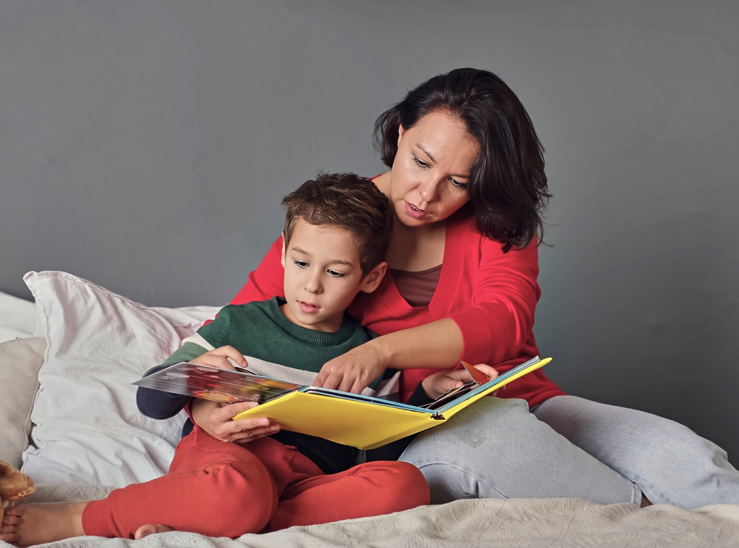 Mother and preschooler reading together. 