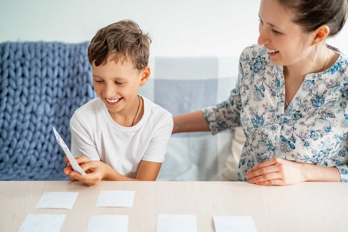 A kindergarten child and his mother playing a sight word matching game. 