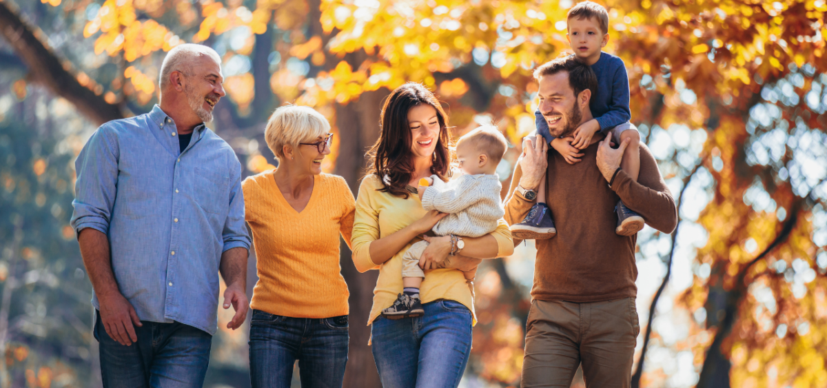 Multi generational family walking together in the fall. 