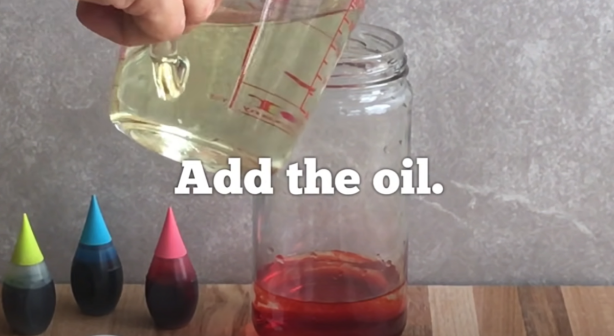 Adding oil to water in order to create a fun science activity. 