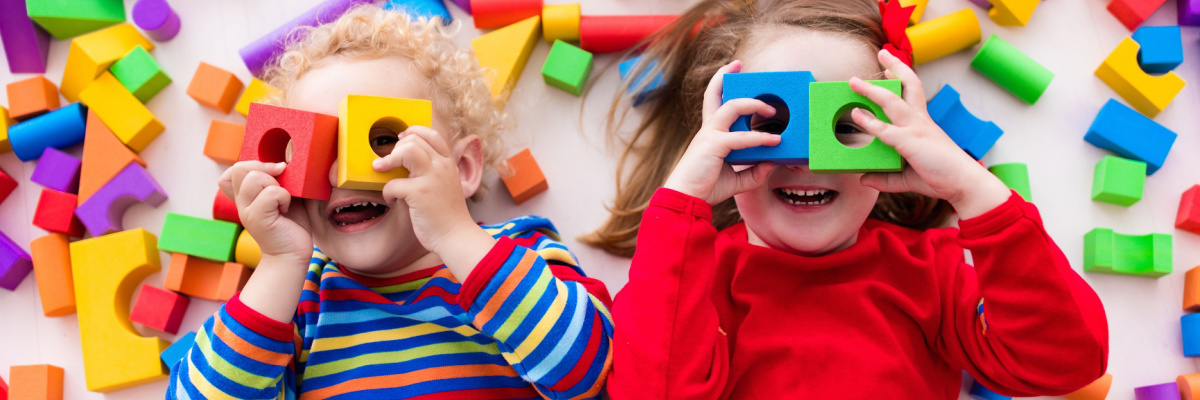 Children having fun playing in a pile of blocks. 