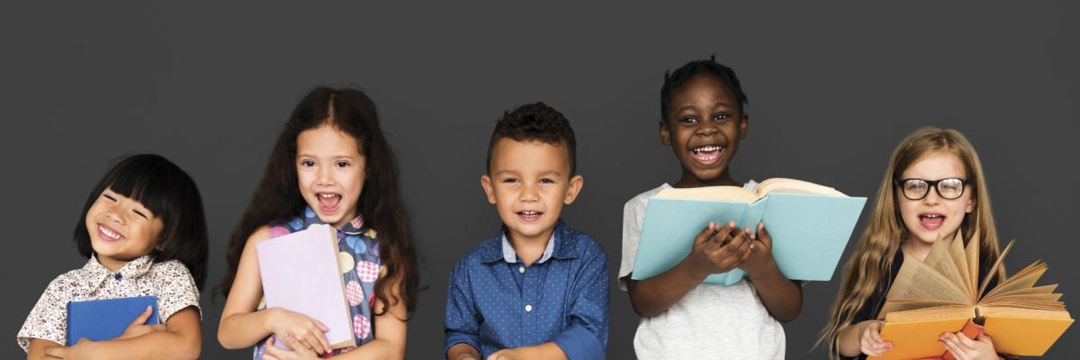 Five happy second graders reading books and smiling. 