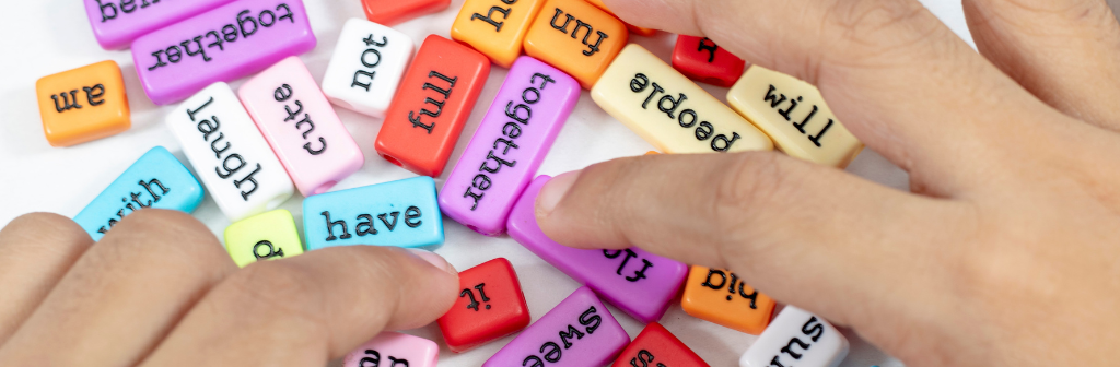 Spelling word beads spread out on top of a table. 