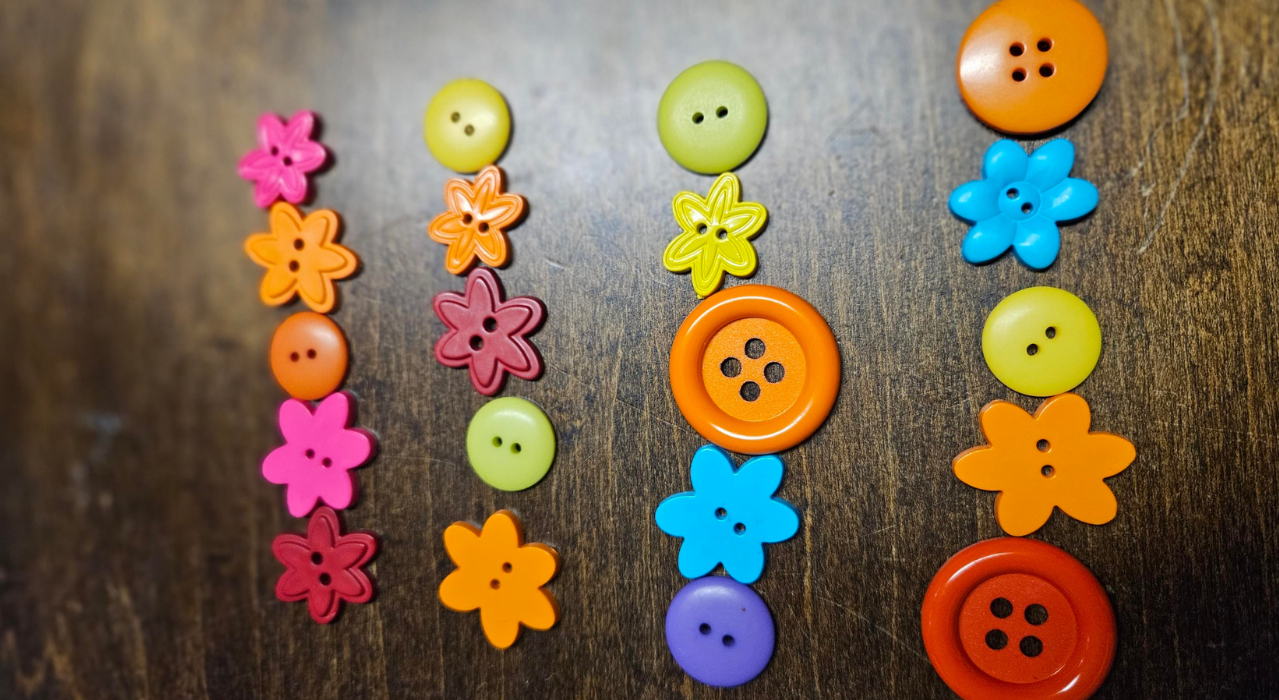 Colorful round and flower buttons showing multiplication. 