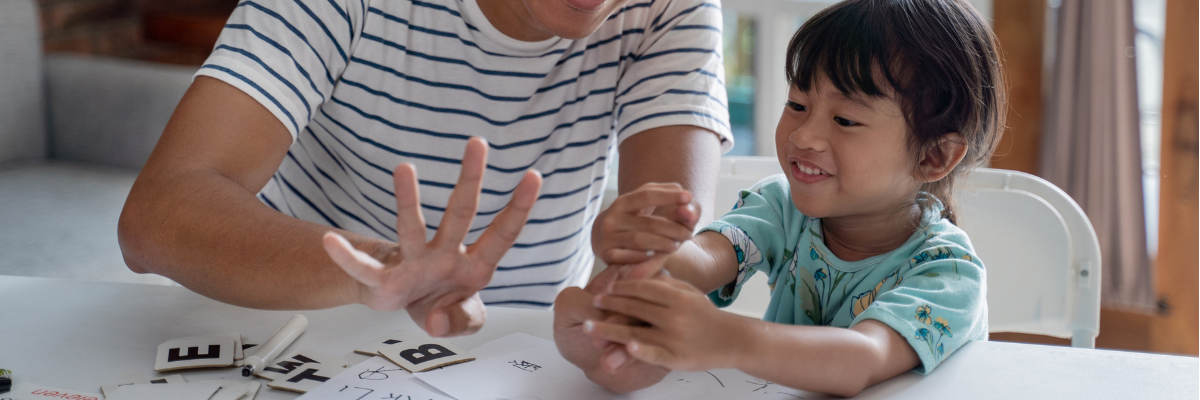 Father teaching his preschool a math concept by counting on his fingers