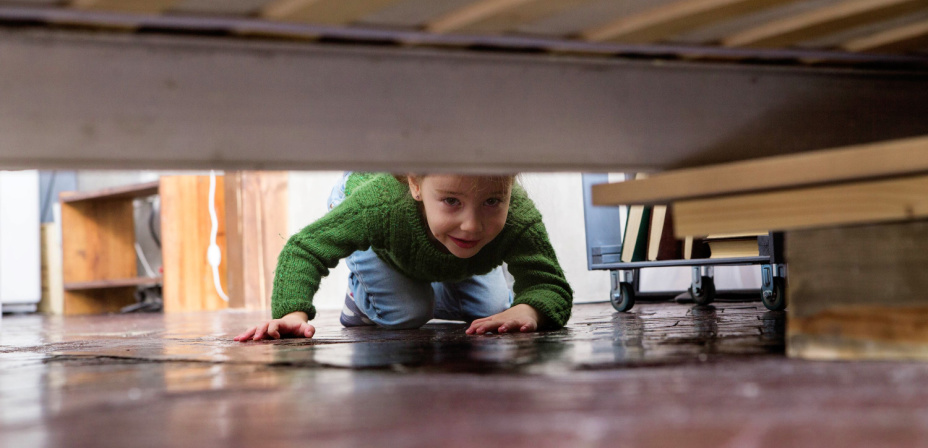 A child looking for letters in a scavenger hunt. 