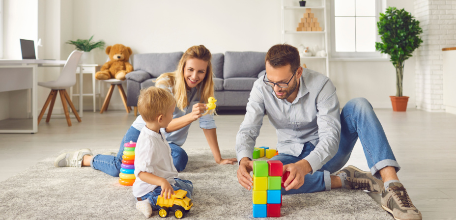 Two parents and their child playing together. 