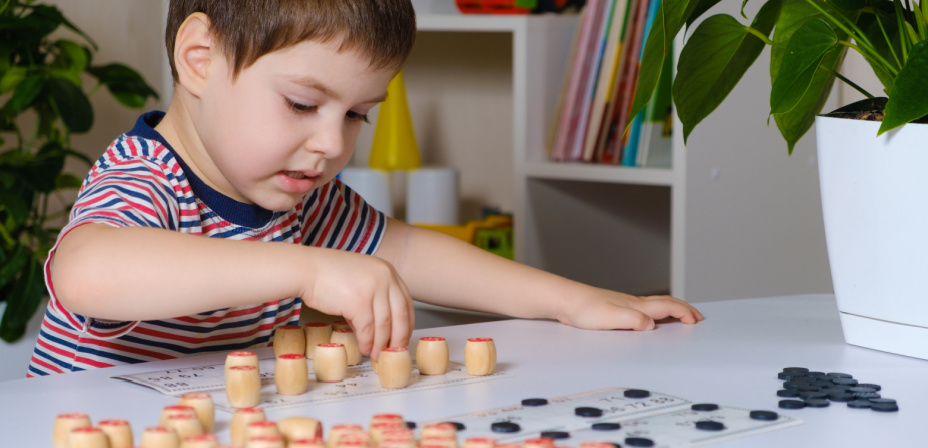A child playing letter sound bingo. 