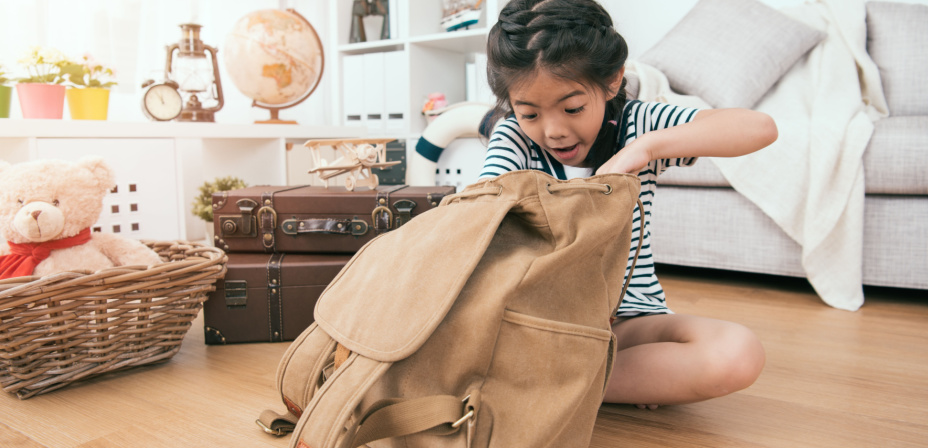 A child looking in a back for missing letters. 