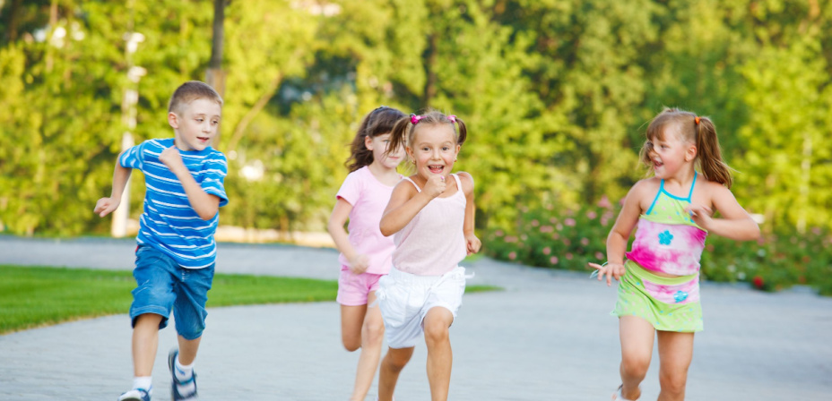 Children running in a letter sound relay race. 