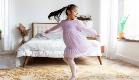 Little girl dancing in her room. 