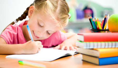 Young girl writing in a journal. 