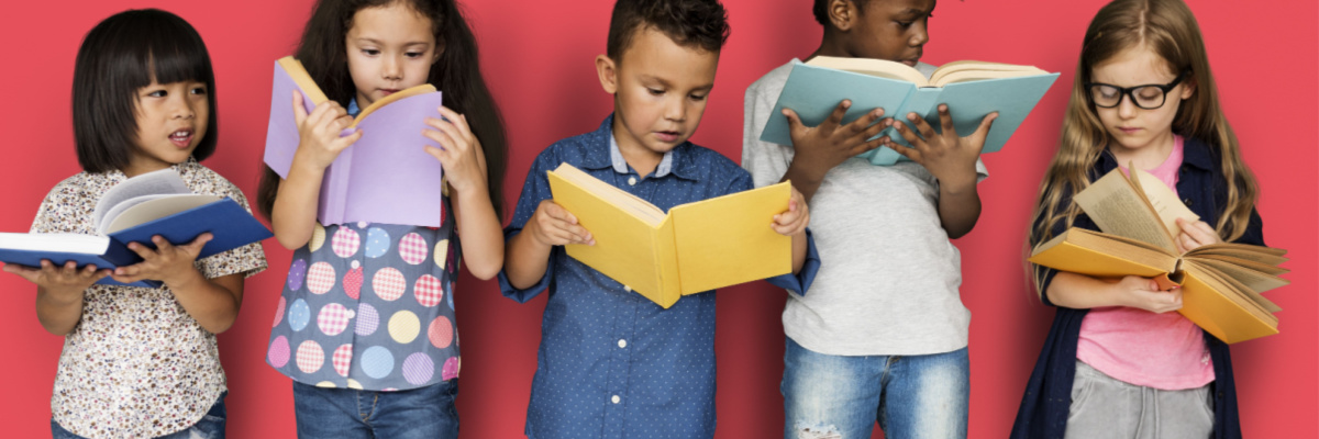 5 children looking at books together. 