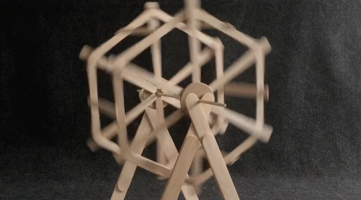 A popsicle stick Ferris wheel spinning. 