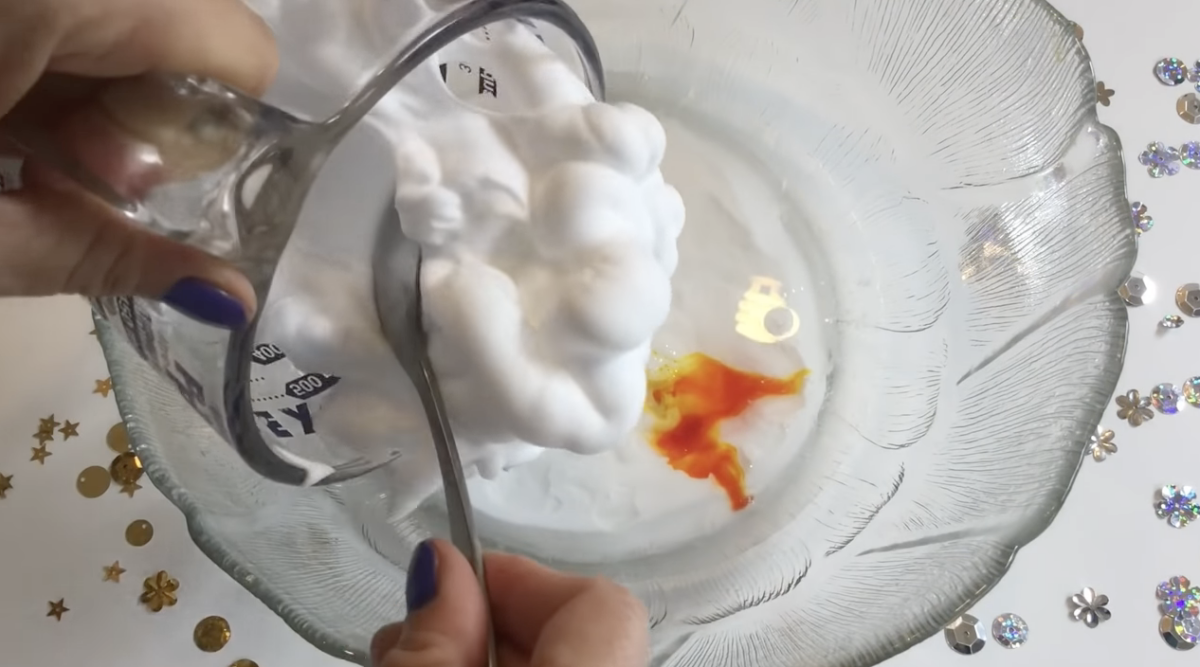 Mixing shaving cream into a bowl of glue and coloring. 