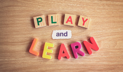 Play and learn written in colorful letter toys. 
