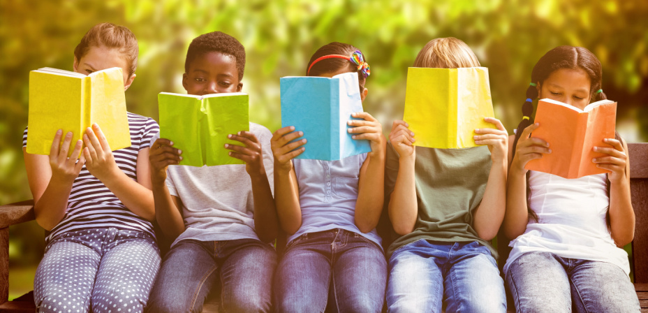 Children sitting in a line reading books. 