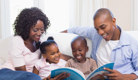 A young family reading books together. 