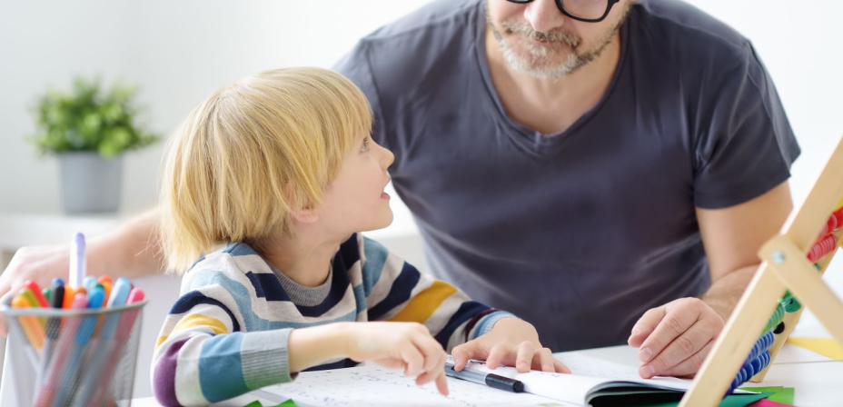 A father helping his son with math homework. 