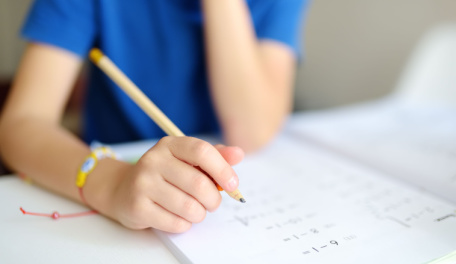 A child doing math homework. 