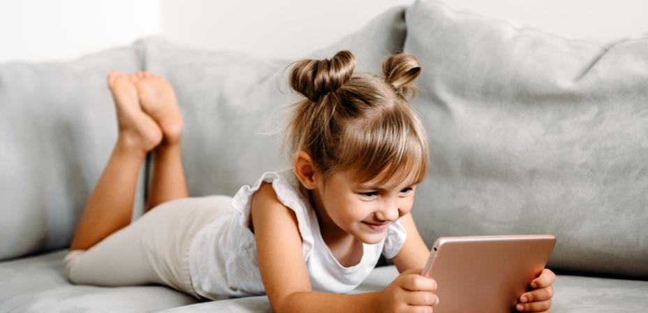 Girl looking at an I-Pad excited. 