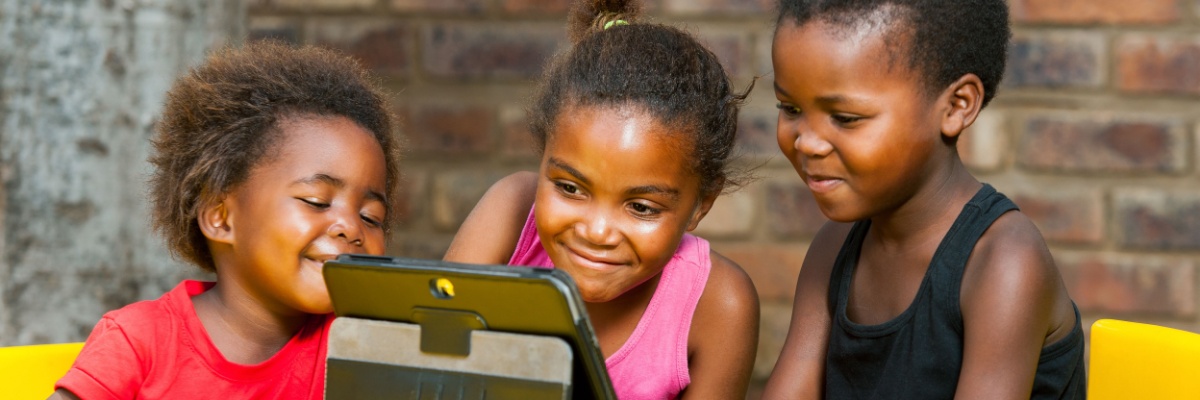 Children looking at an ipad for learning. 
