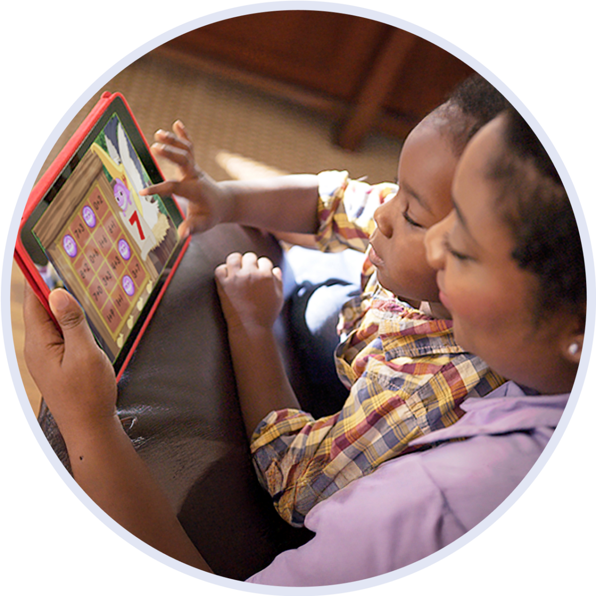 A young child and his mother playing the ABCmouse app together on an i-pad.