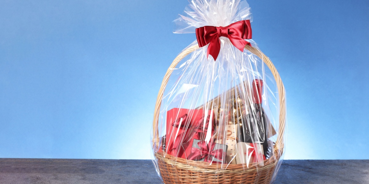 Gift basket wrapped in clear cellophane with a red bow, illustrating the importance of expressing gratitude and appreciation.