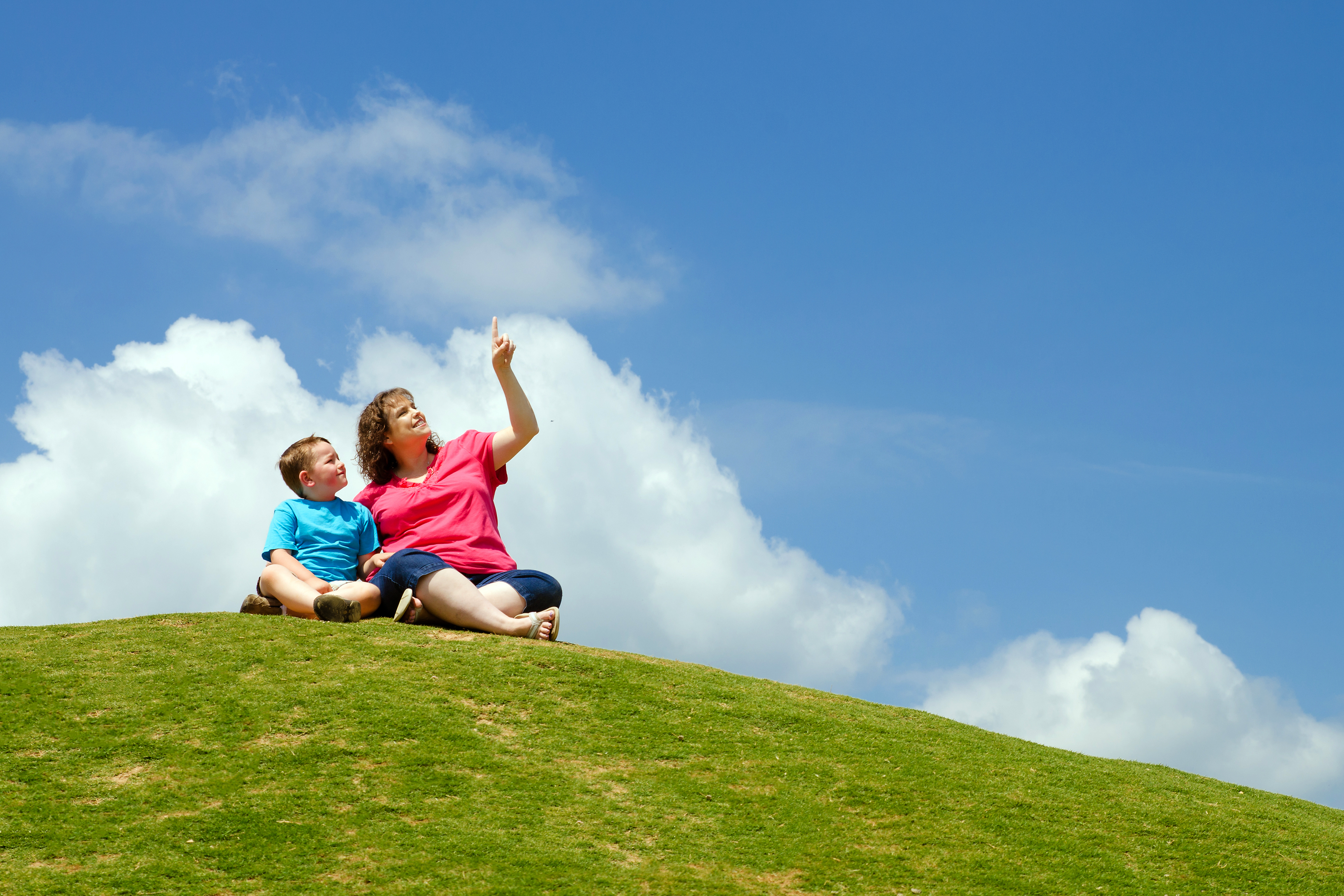 A mother and her son looking at clouds for a fun summer activity, 