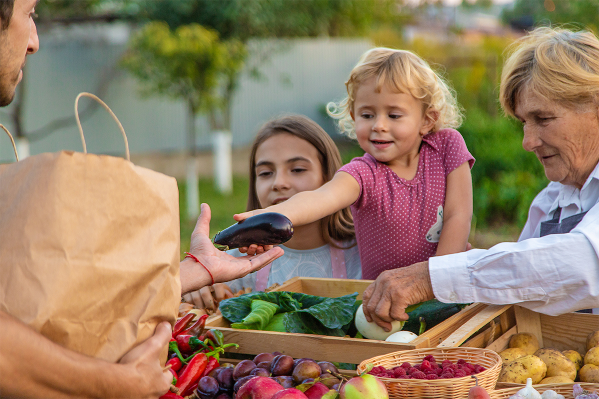 A young family at the farmers market  for a fun summer activity. 