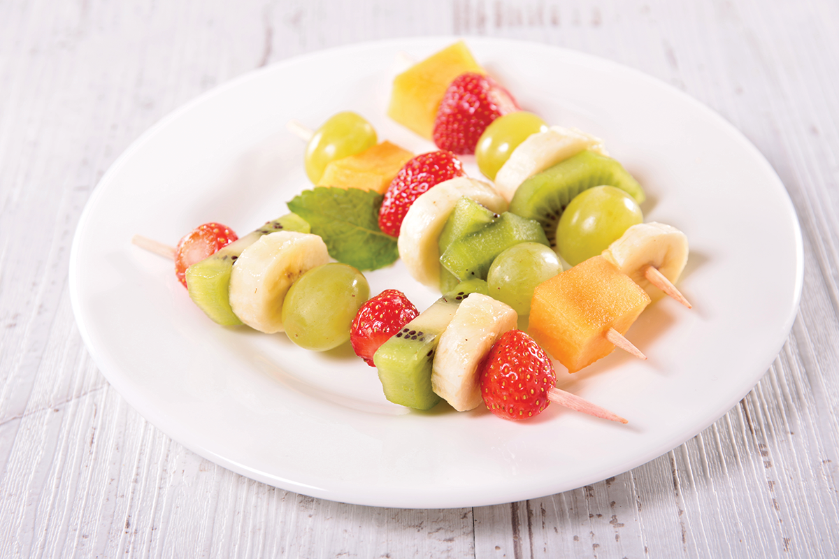 Making fruit kabobs  for a fun summer activity. 