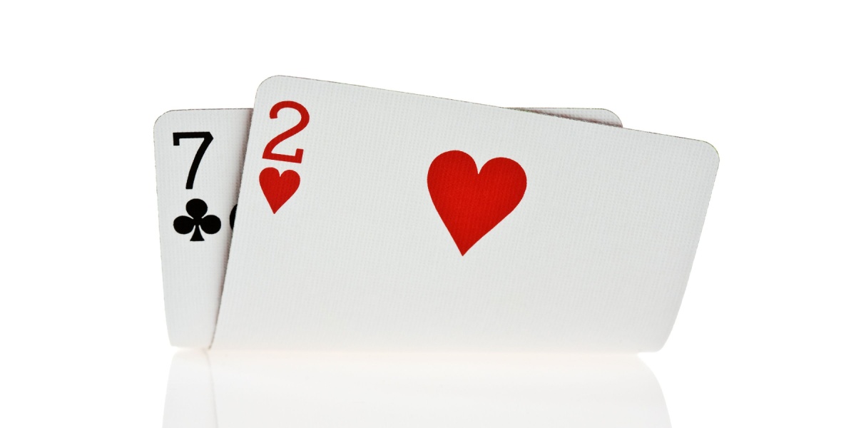 A seven of clubs and a two of diamonds playing cards. 