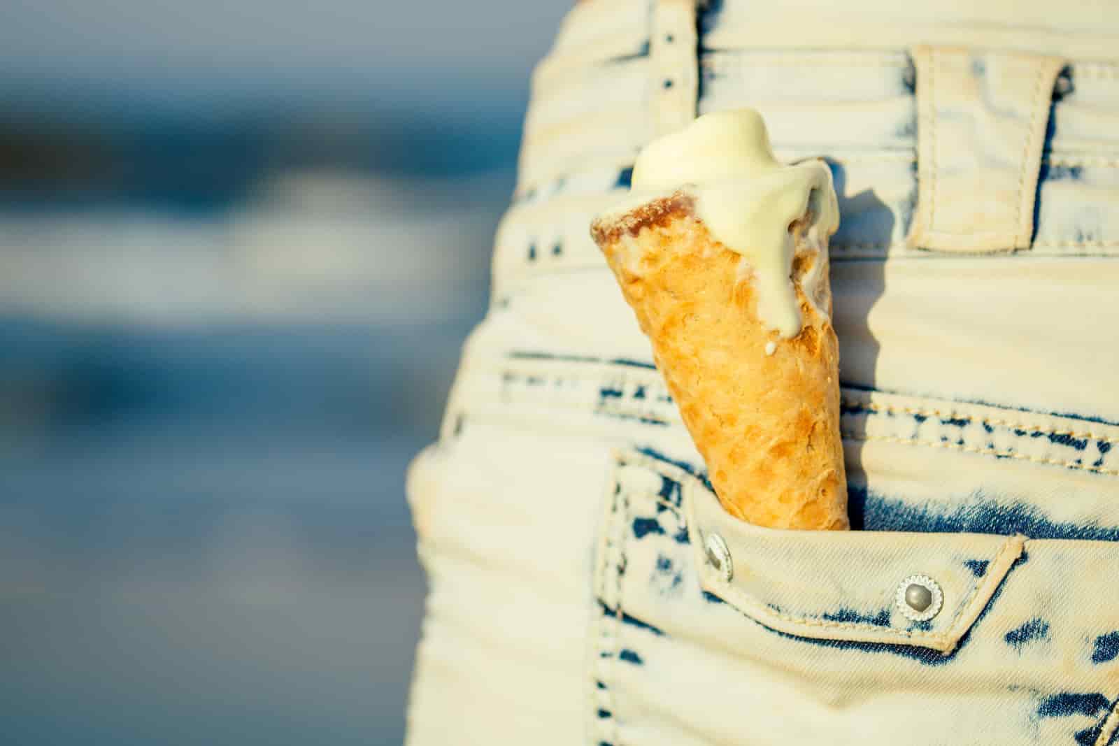A melting ice cream cone in a jeans back pocket. 