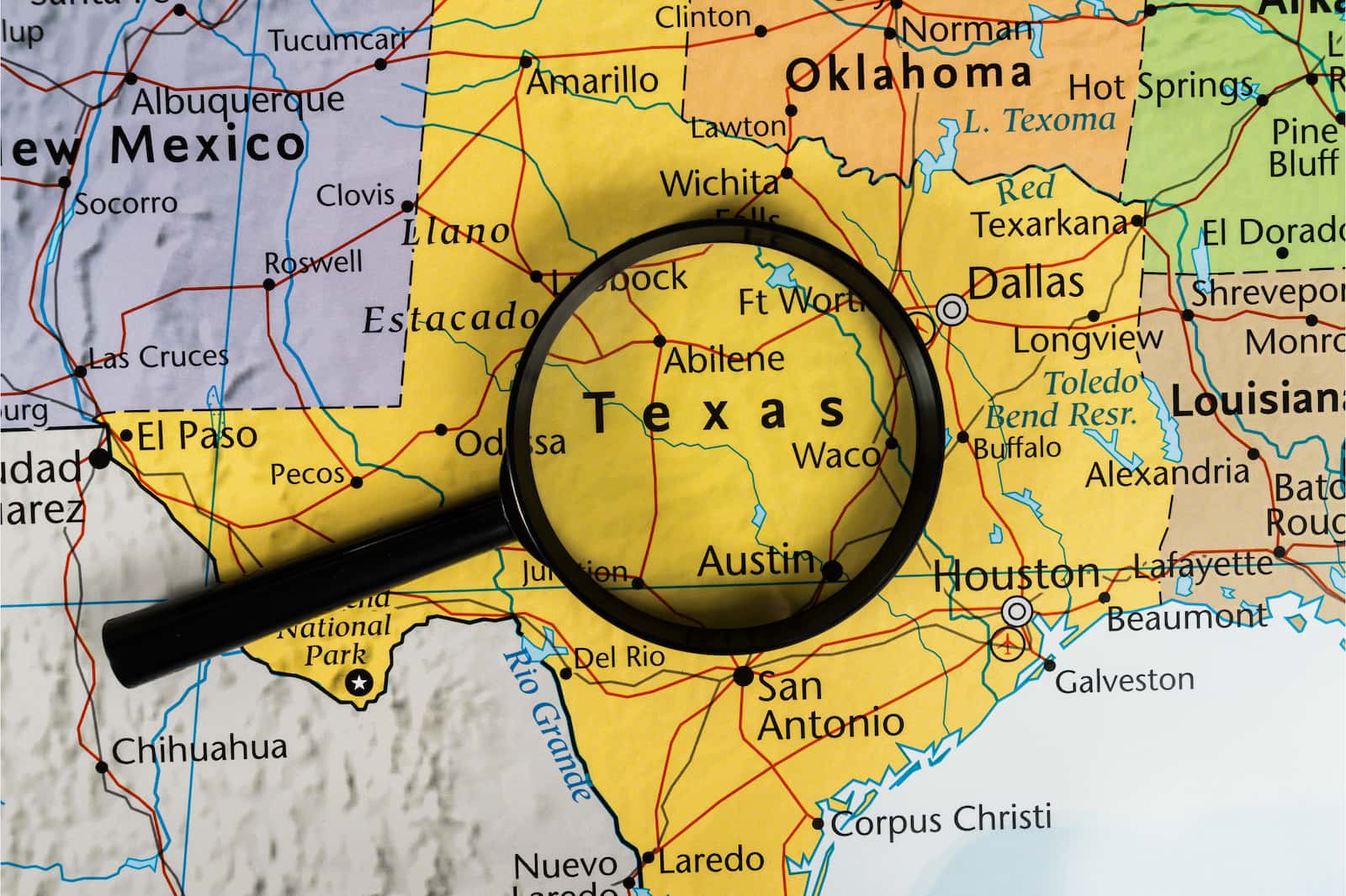 State of Texas on a map with a magnifying glass on it. 