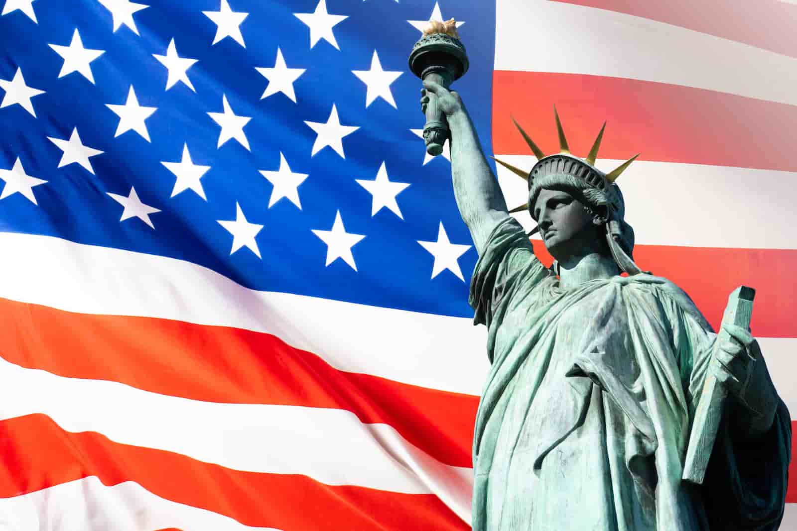 Statue of Liberty next to USA flag