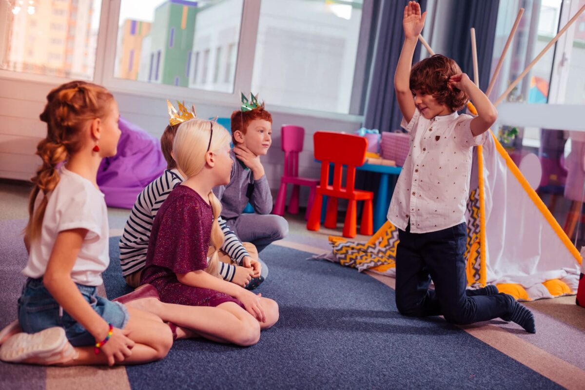 A group of kids playing charades. 